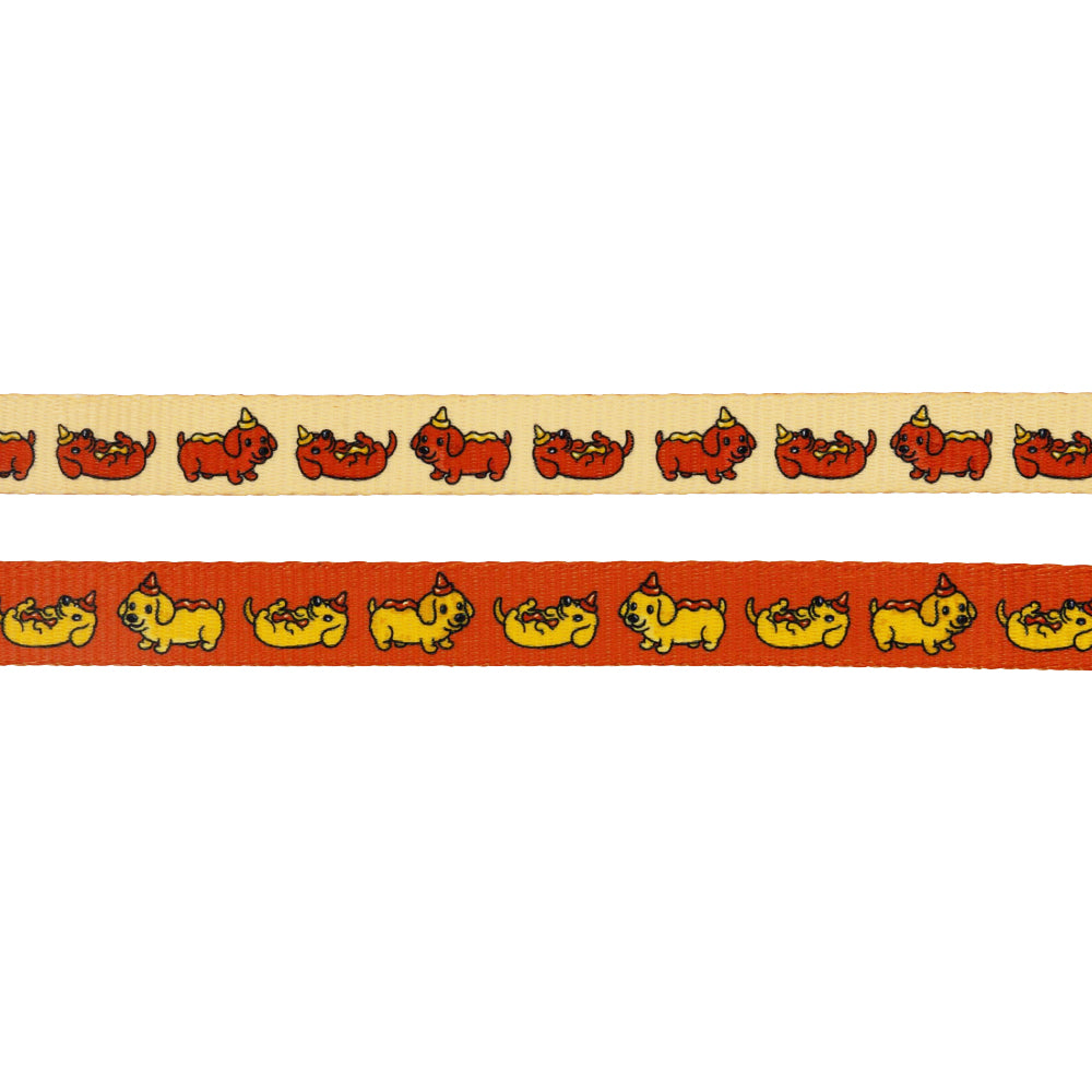 The Sassy Woof Dog Four Piece Bundle - Hot Dawg features two ribbon strips, beige and orange, with fun red and yellow cartoon dogs—perfect for weenie-themed collections or DIY dachshund gifts.
