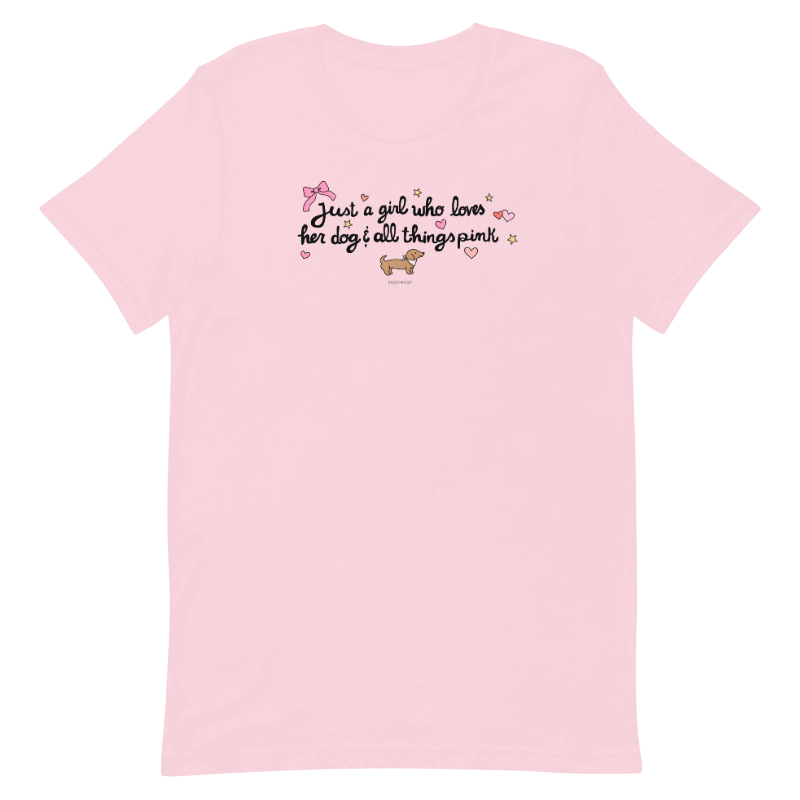 The Sassy Woof Just A Girl Tee is a light pink girl’s t-shirt featuring “Just a girl who loves her dog & all things pink” in playful font, with a cartoon dog, stars, hearts, and bow—printed using eco-friendly ink.
