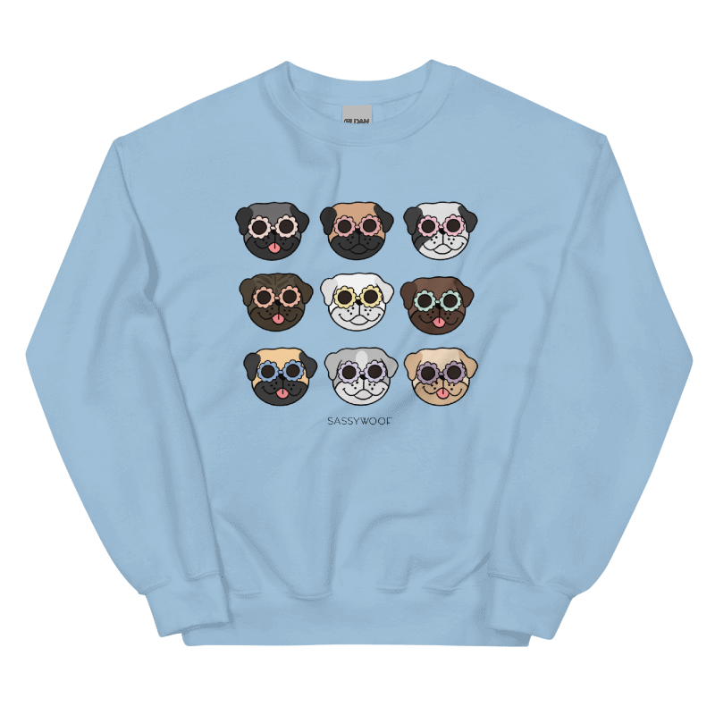 The Sassy Woof Sweatshirt - Pugs is a light blue unisex crewneck featuring a 3x3 grid of cartoon pugs in colorful sunglasses, with "SASSYWOOF" printed below the playful design.