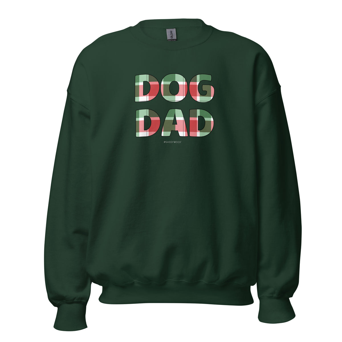 The Sassy Woof Sweatshirt Dog Dad Jingle Barks is a dark green, classic fit sweater featuring "DOG DAD" in bold red, white, and green plaid. Pre-shrunk for lasting warmth, comfort, and style.