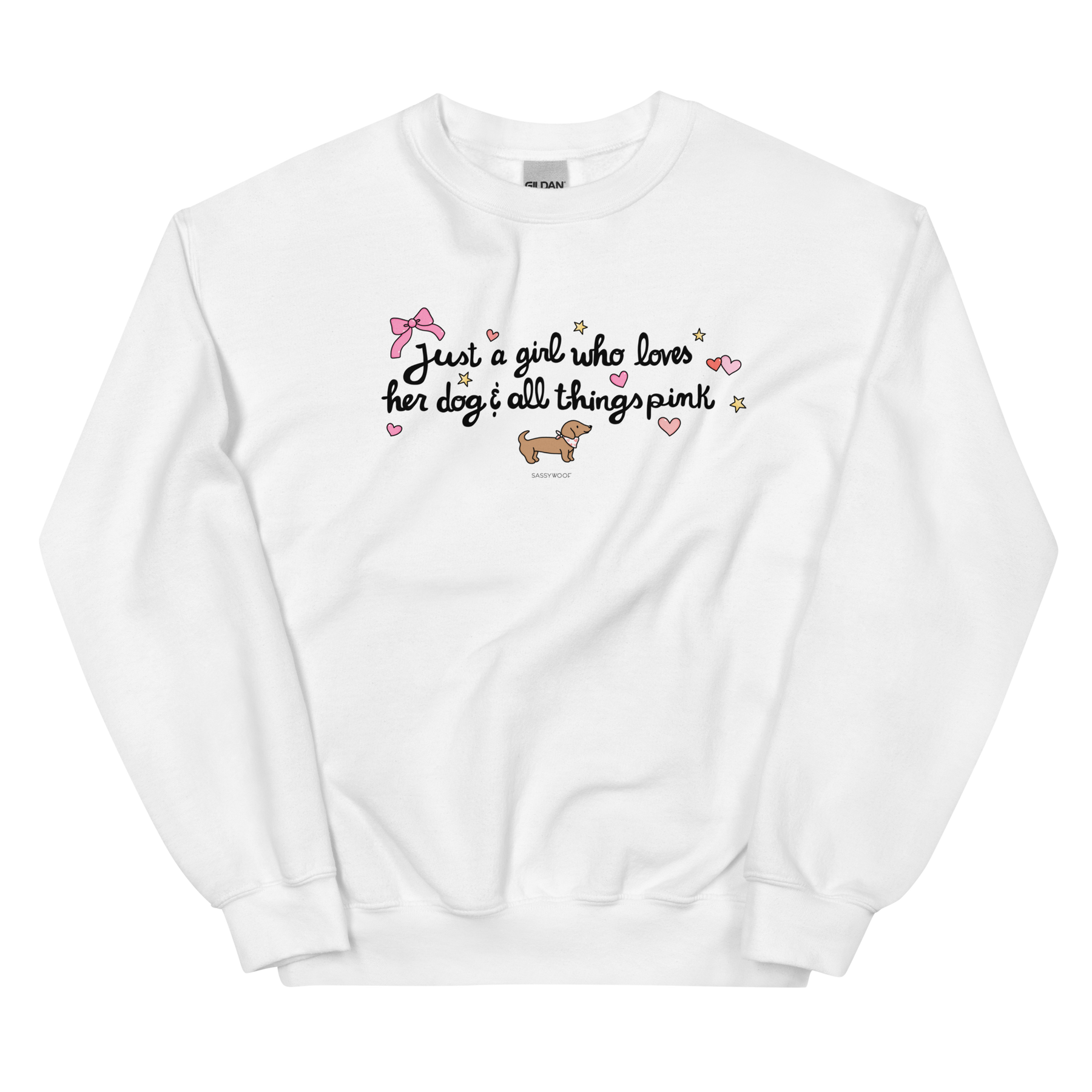 The Sassy Woof Sweatshirt - Just A Girl features playful fonts, pink hearts, a pink bow, a brown dachshund, and gold stars on white; classic fit and pre-shrunk for comfort—perfect for dog lovers who adore all things pink.
