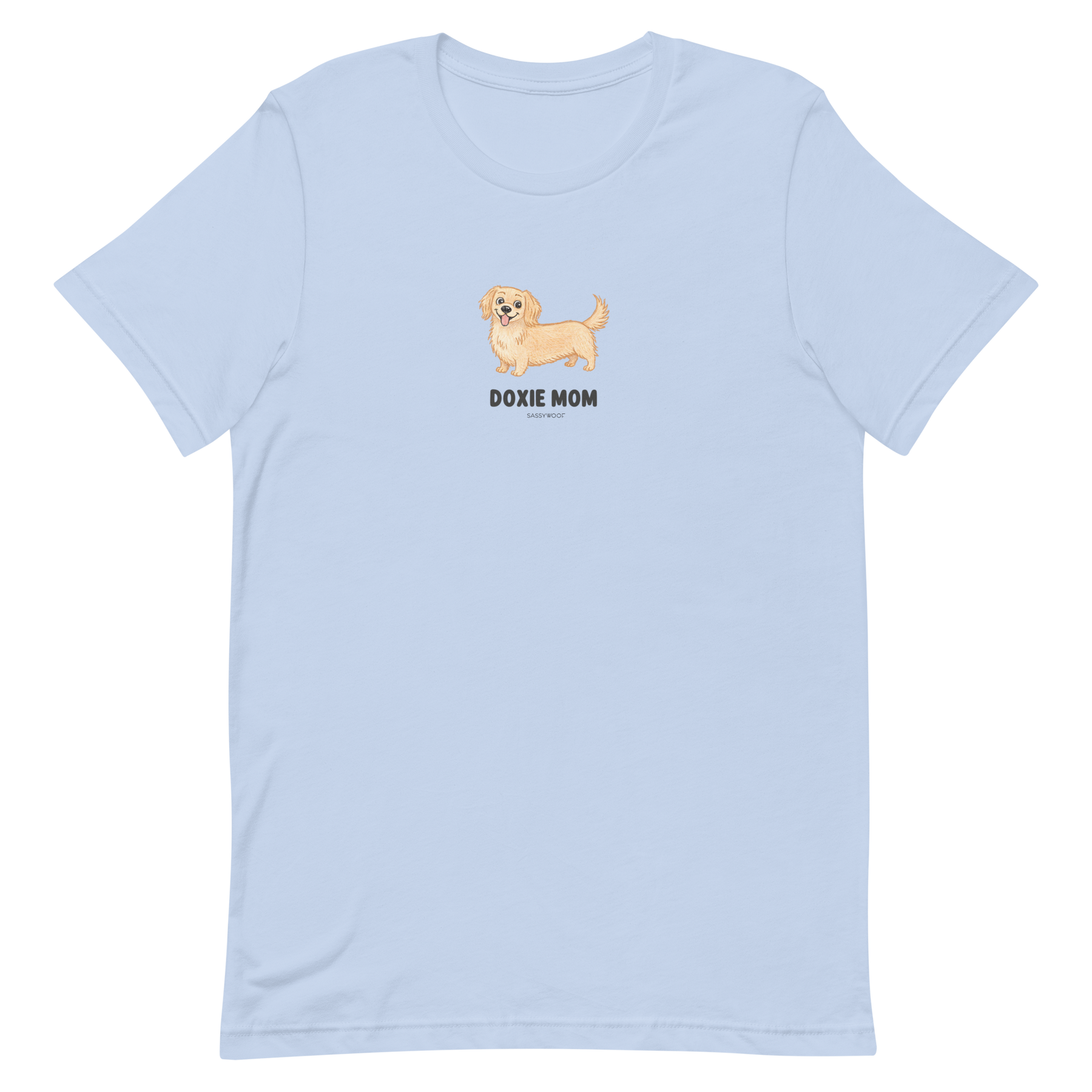 The Doxie Mom Tee by Sassy Woof is a light blue unisex shirt with a small tan dachshund illustration above bold black "DOXIE MOM" lettering on the chest.