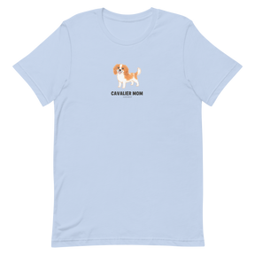 The Sassy Woof Cavalier Mom Tee is a light blue unisex dog shirt with a Cavalier King Charles Spaniel illustration above "CAVALIER MOM" in black—perfect for any proud Cavalier mom or breed lover.