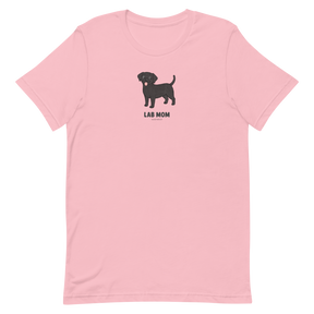 The Sassy Woof Lab Mom Tee is a light pink unisex shirt with a black Labrador retriever illustration above bold "LAB MOM" text—ideal for any proud pet parent.
