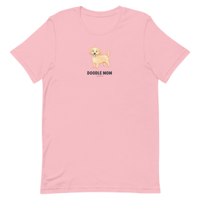 The Sassy Woof Doodle Mom Tee is a light pink unisex shirt with a smiling doodle dog graphic and bold “DOODLE MOM” text—perfect for any proud Doodle Mom.