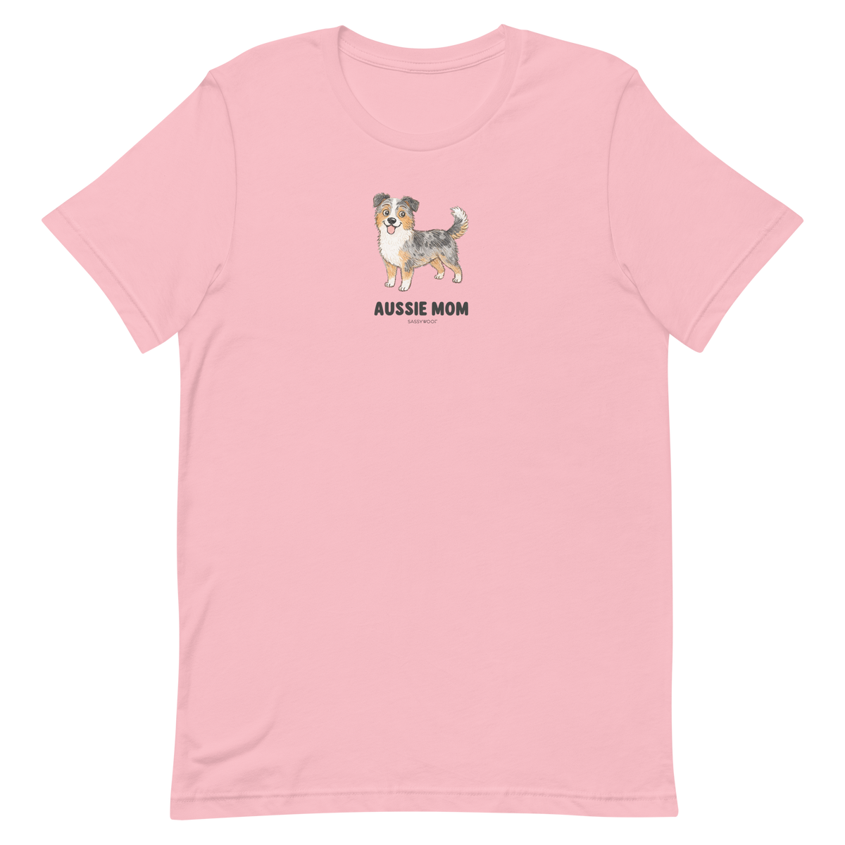The Aussie Mom Tee by Sassy Woof is a light pink unisex shirt with an illustrated Australian Shepherd and bold black lettering, made from eco-friendly cotton—perfect for stylish, proud dog parents.