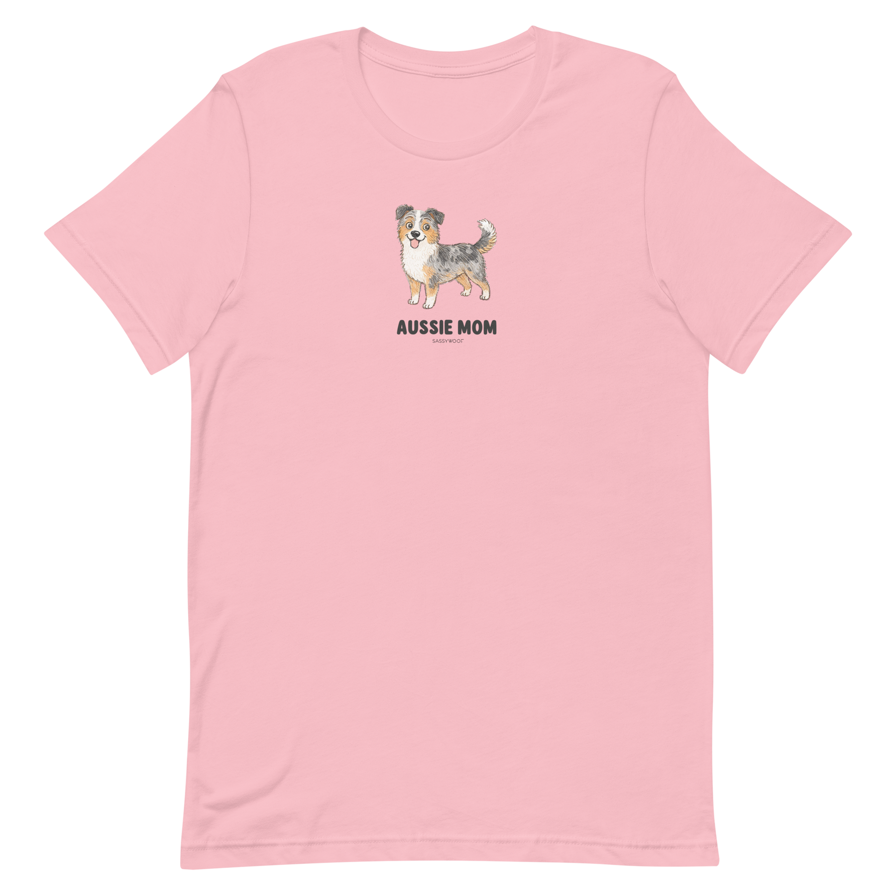 The Aussie Mom Tee by Sassy Woof is a light pink unisex shirt with an illustrated Australian Shepherd and bold black lettering, made from eco-friendly cotton—perfect for stylish, proud dog parents.
