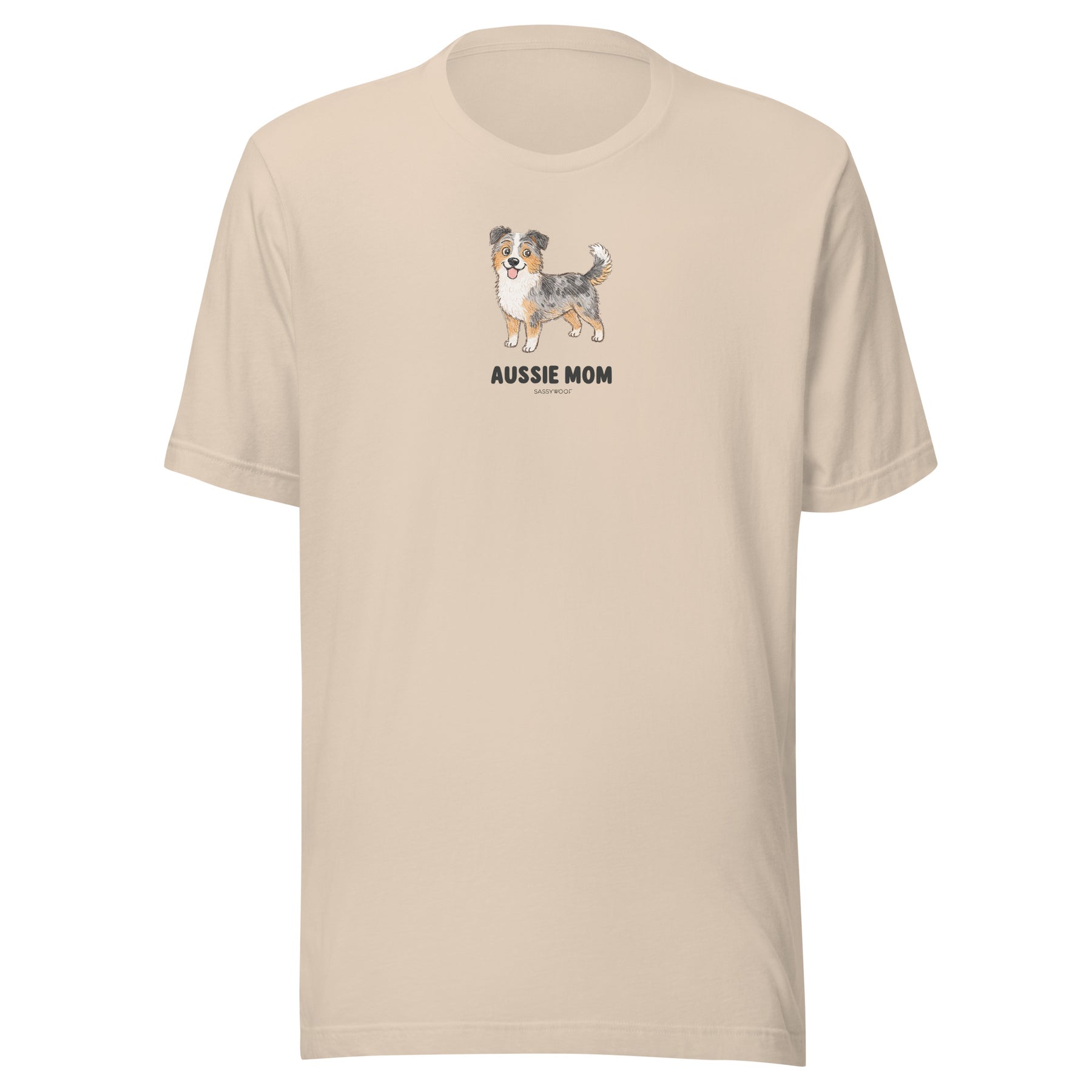 The Sassy Woof Aussie Mom Tee is a beige unisex cotton t-shirt with an Australian Shepherd illustration and bold "AUSSIE MOM" text on the chest—perfect for proud Aussie moms.