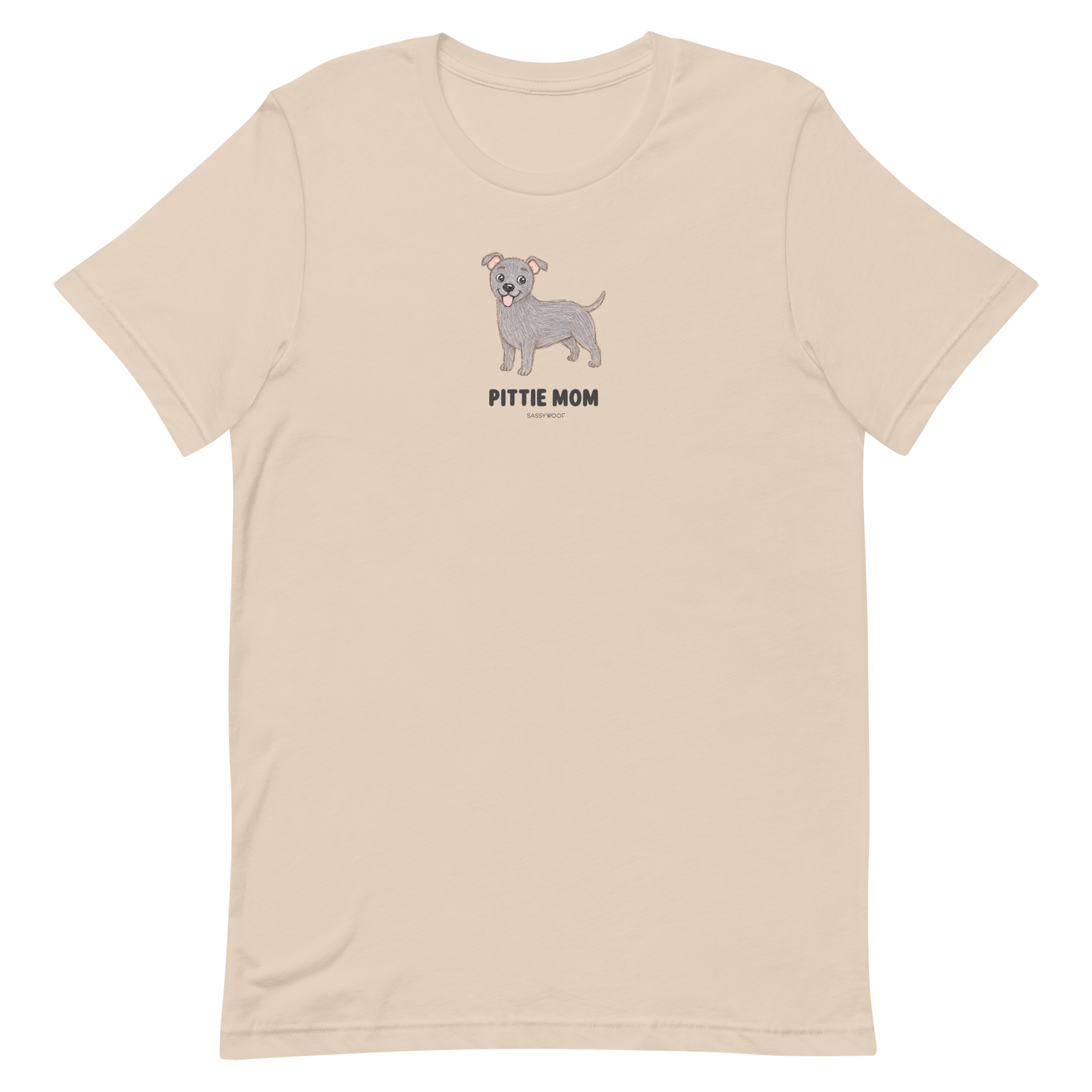 The Pittie Mom Tee by Sassy Woof is a light beige unisex shirt with a cartoon grey pitbull and "PITTIE MOM" text—perfect for pitbull lovers to show off their pup pride.