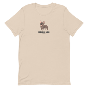 The Sassy Woof Frenchie Mom Tee is a beige t-shirt with a small brown French Bulldog illustration and "FRENCHIE MOM" text on the front—perfect for any breed t-shirt collection.