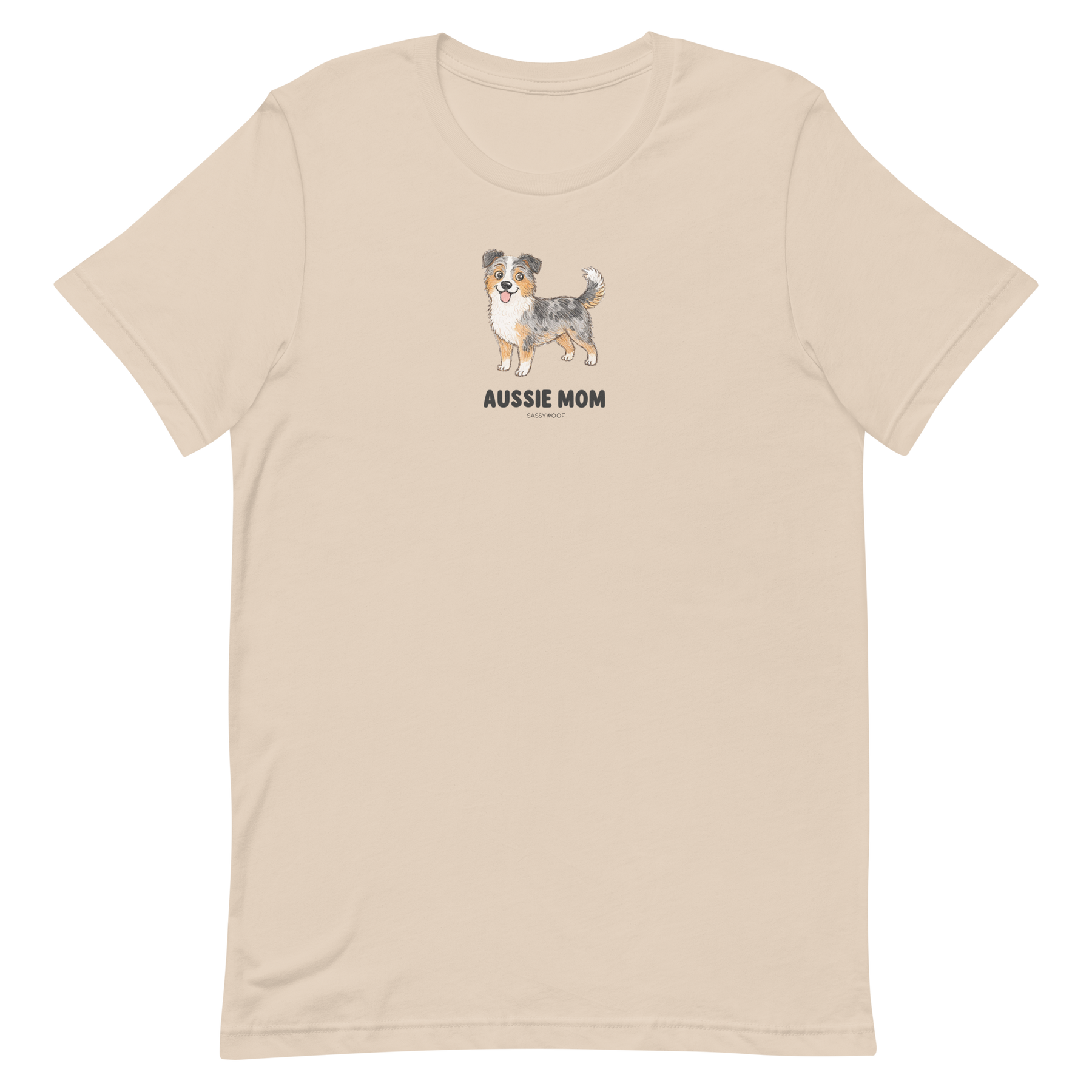 The Sassy Woof Aussie Mom Tee is a beige unisex shirt with an Australian Shepherd illustration above bold text, made from soft, eco-friendly cotton for comfort and style.