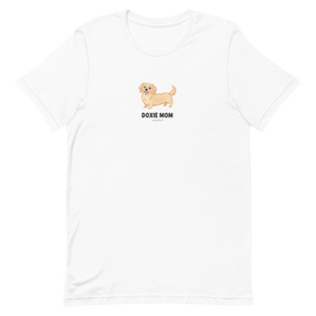 The Sassy Woof Doxie Mom Tee features a cartoon tan dachshund above bold black text, centered on the chest. This unisex shirt is perfect for dachshund moms who want to show their love for their favorite breed in style.