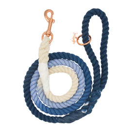 The Sassy Woof Dog Rope Leash - Ombre Blue features a hand-crafted cotton rope with a sturdy metal clasp and a stylish gradient from cream to light blue to dark blue, combining durability with fashionable design.