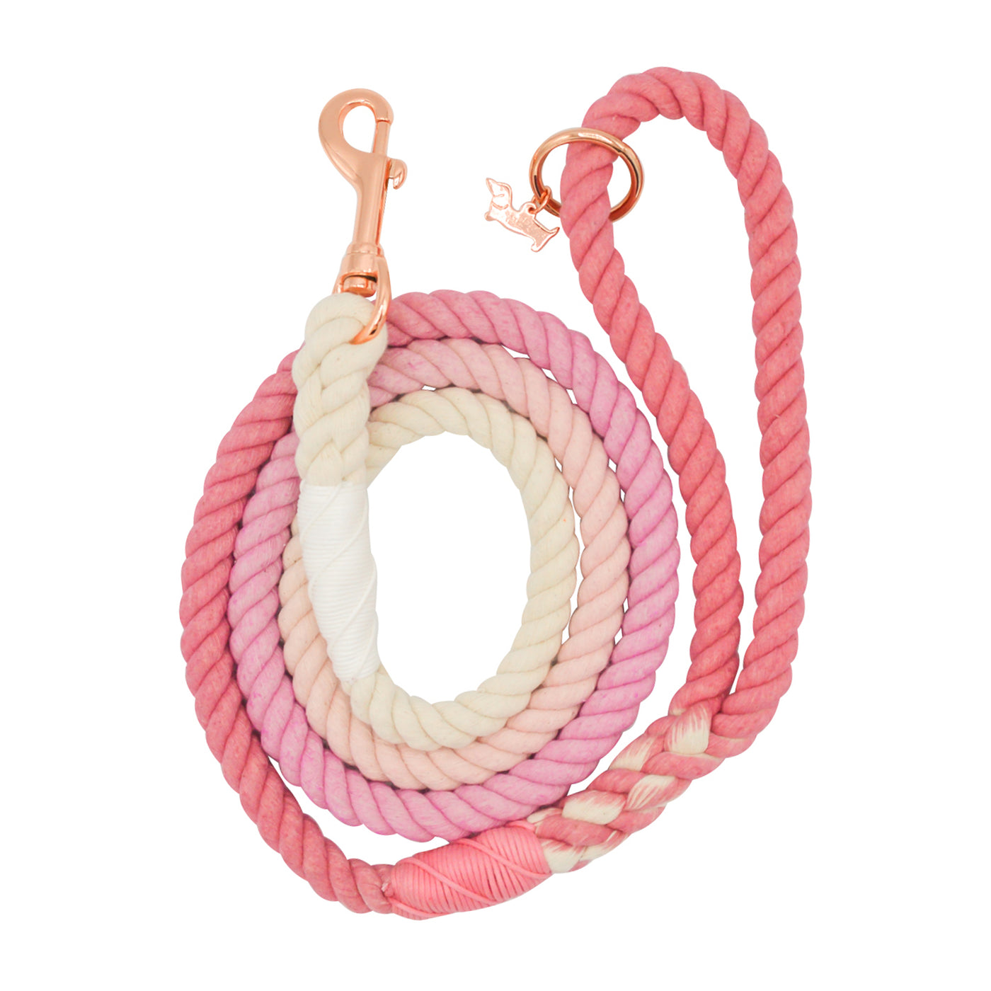The Sassy Woof Dog Rope Leash - Rosie is a coiled cotton leash with a white-to-pink gradient, featuring a loop handle and metal clip accented with rose gold hardware for a stylish look.