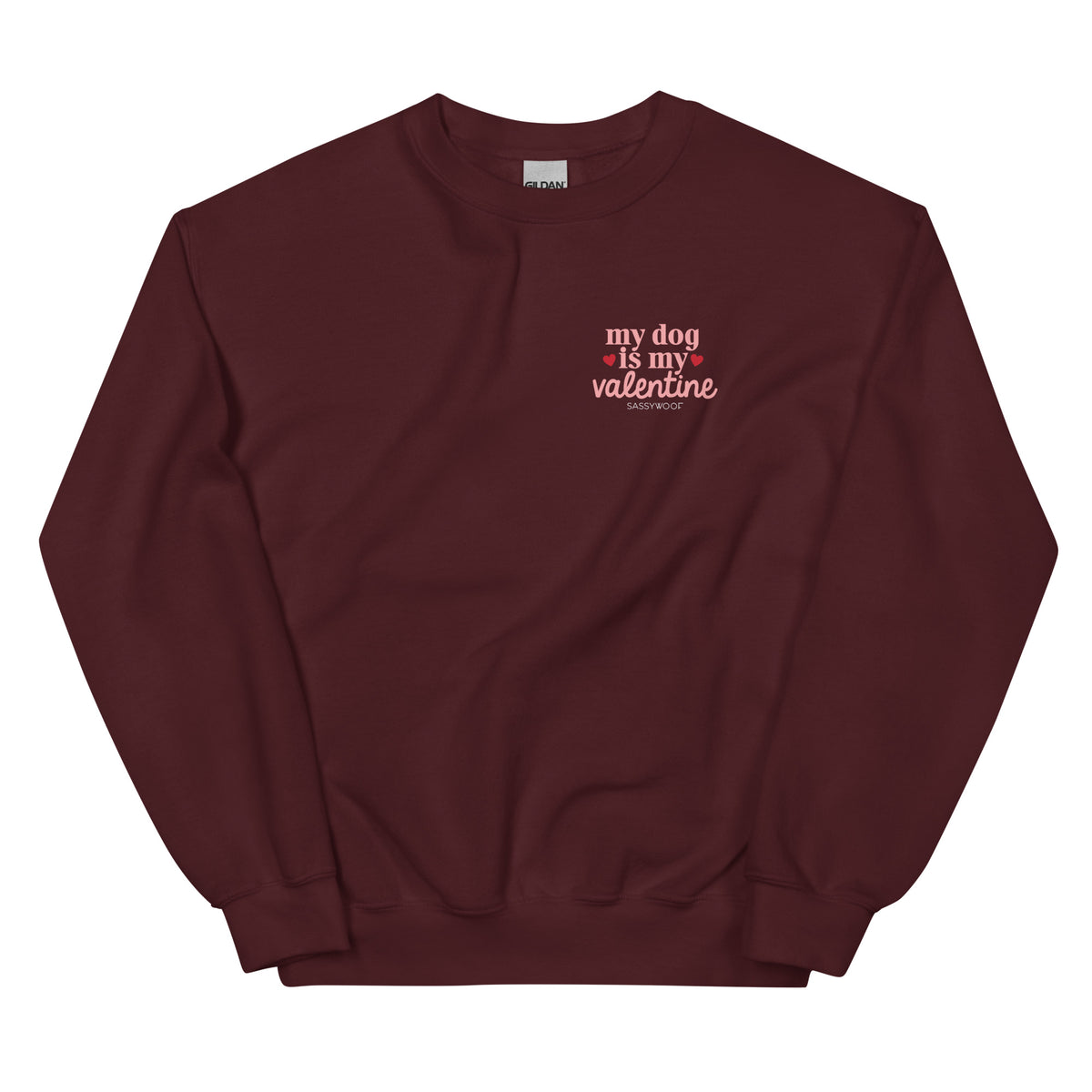 The Sassy Woof "Sweatshirt - My Dog is My Valentine (Dark)" features white and pink text with small pink hearts on maroon—perfect for any dog lover looking to celebrate Valentine’s Day in style.